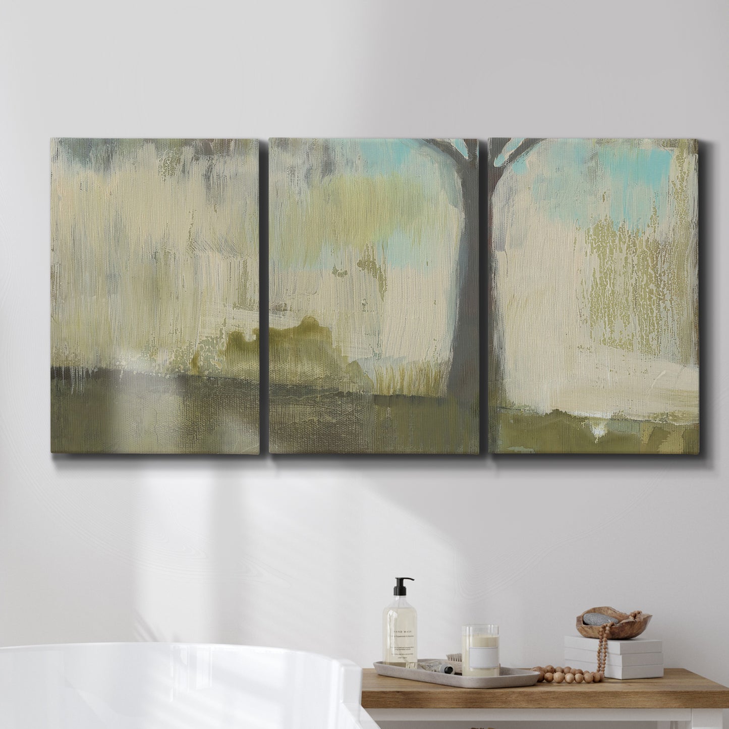 Three-panel canvas wall art featuring tall abstract tree form, displayed in a bathroom above a bathtub.