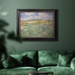 Impressionist countryside landscape near Auvers by Vincent van Gogh in an ornate black frame with gilded inner detail displayed in a dark-toned interior setting.