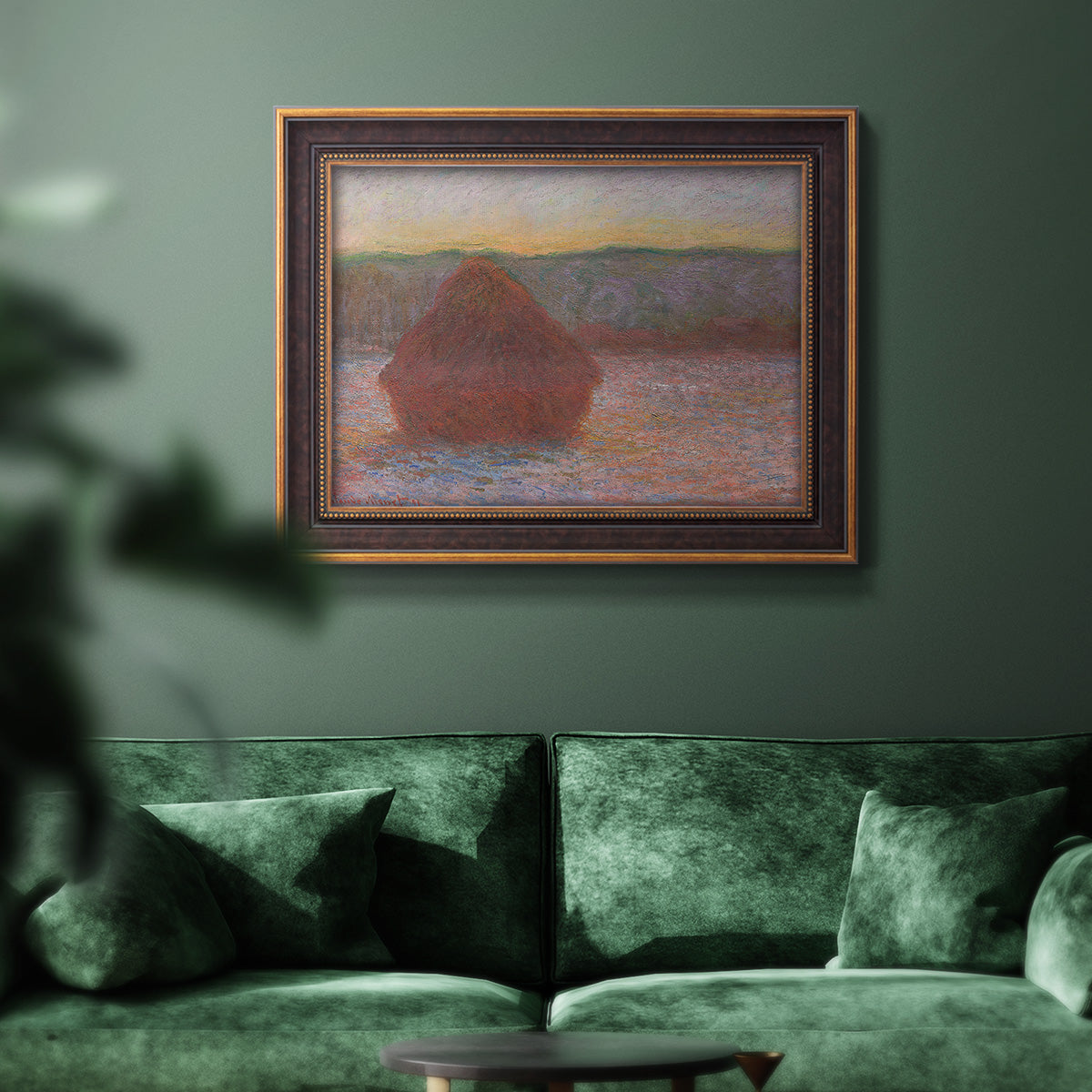 Impressionist haystack sunset scene in winter by Claude Monet in an ornate bronzed mahogany wood frame displayed in a dark-toned interior setting.