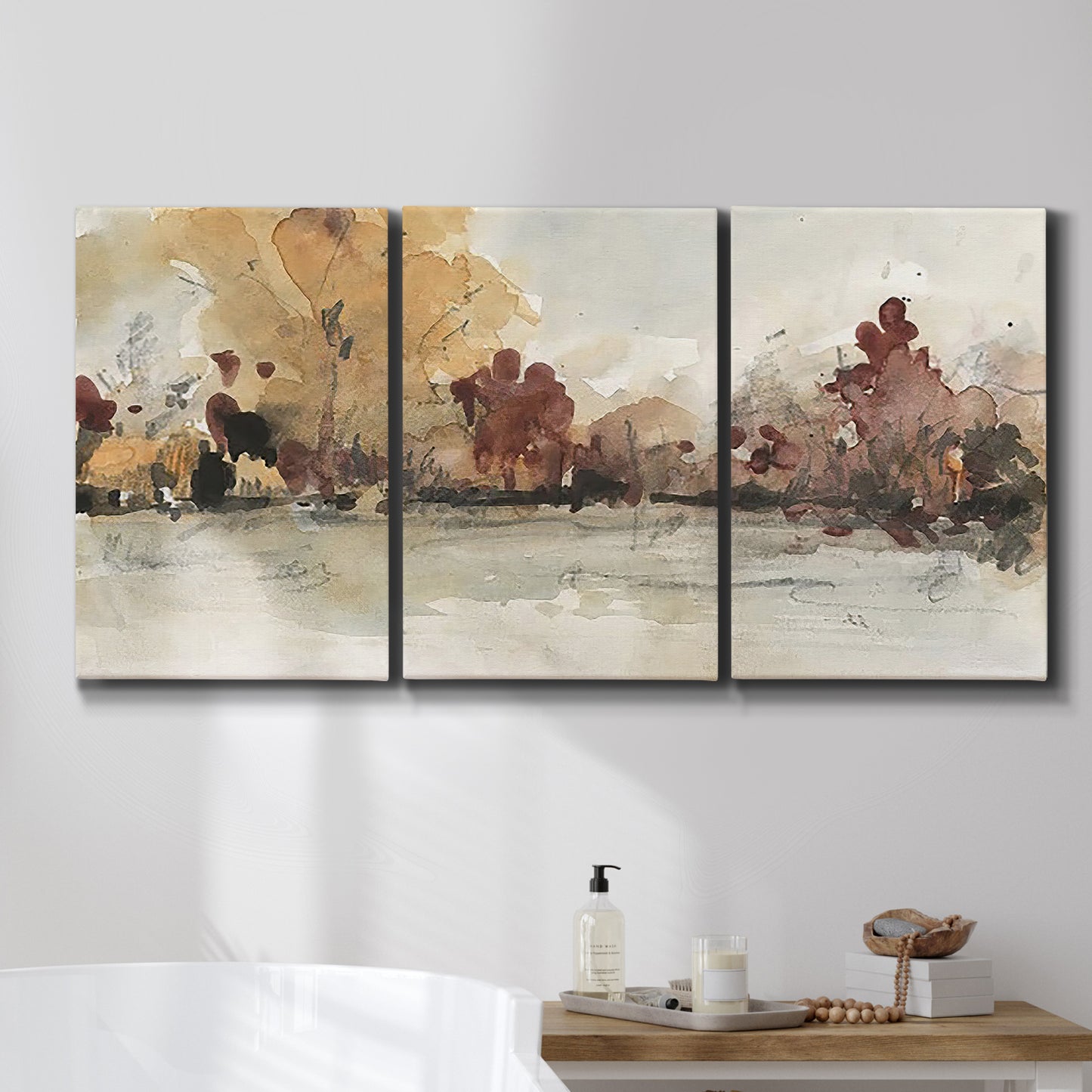 Three-panel canvas wall art featuring autumn landscape with trees and field, displayed in a bathroom above a bathtub.