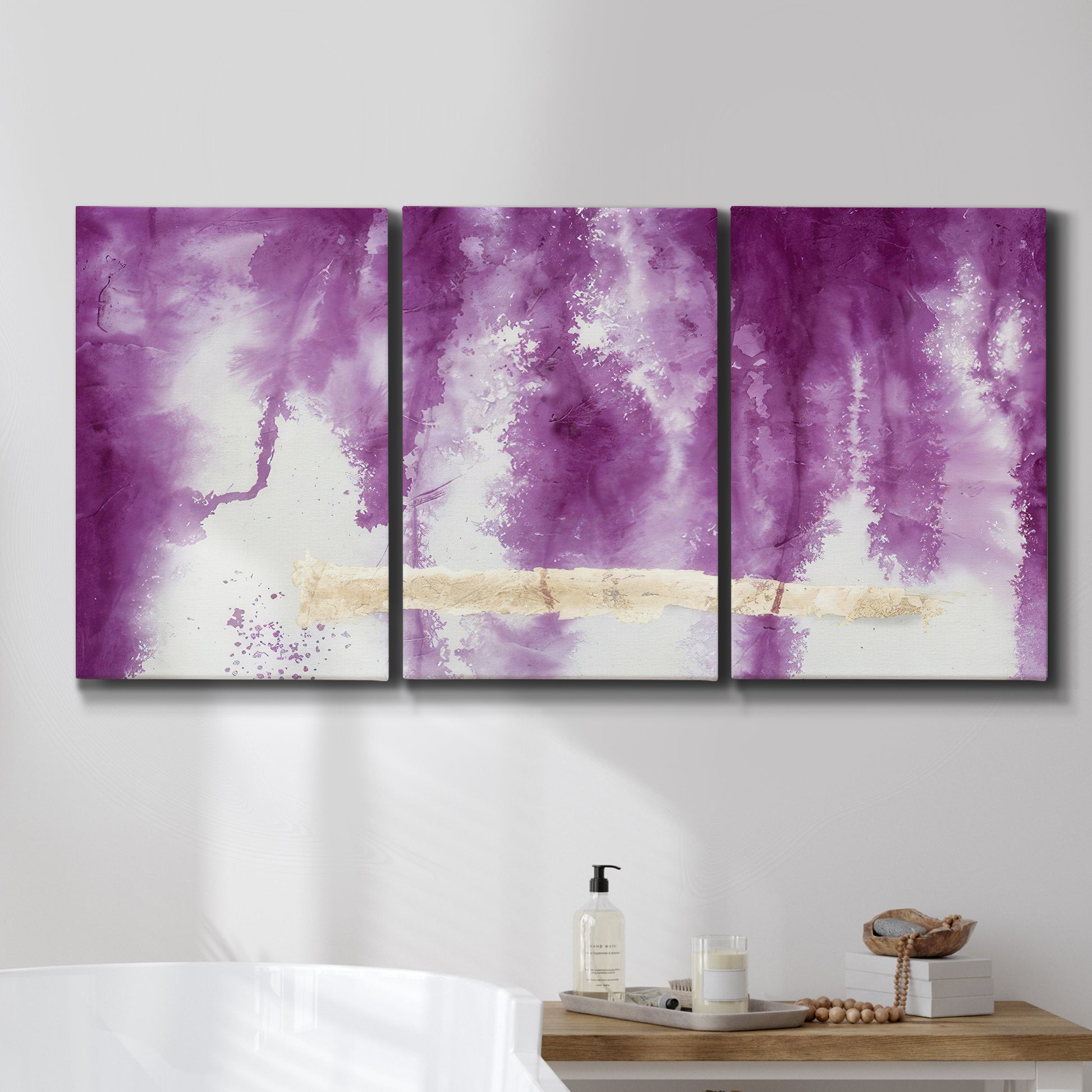 Three-panel canvas wall art featuring saturated abstract color fields, displayed in a bathroom above a bathtub.