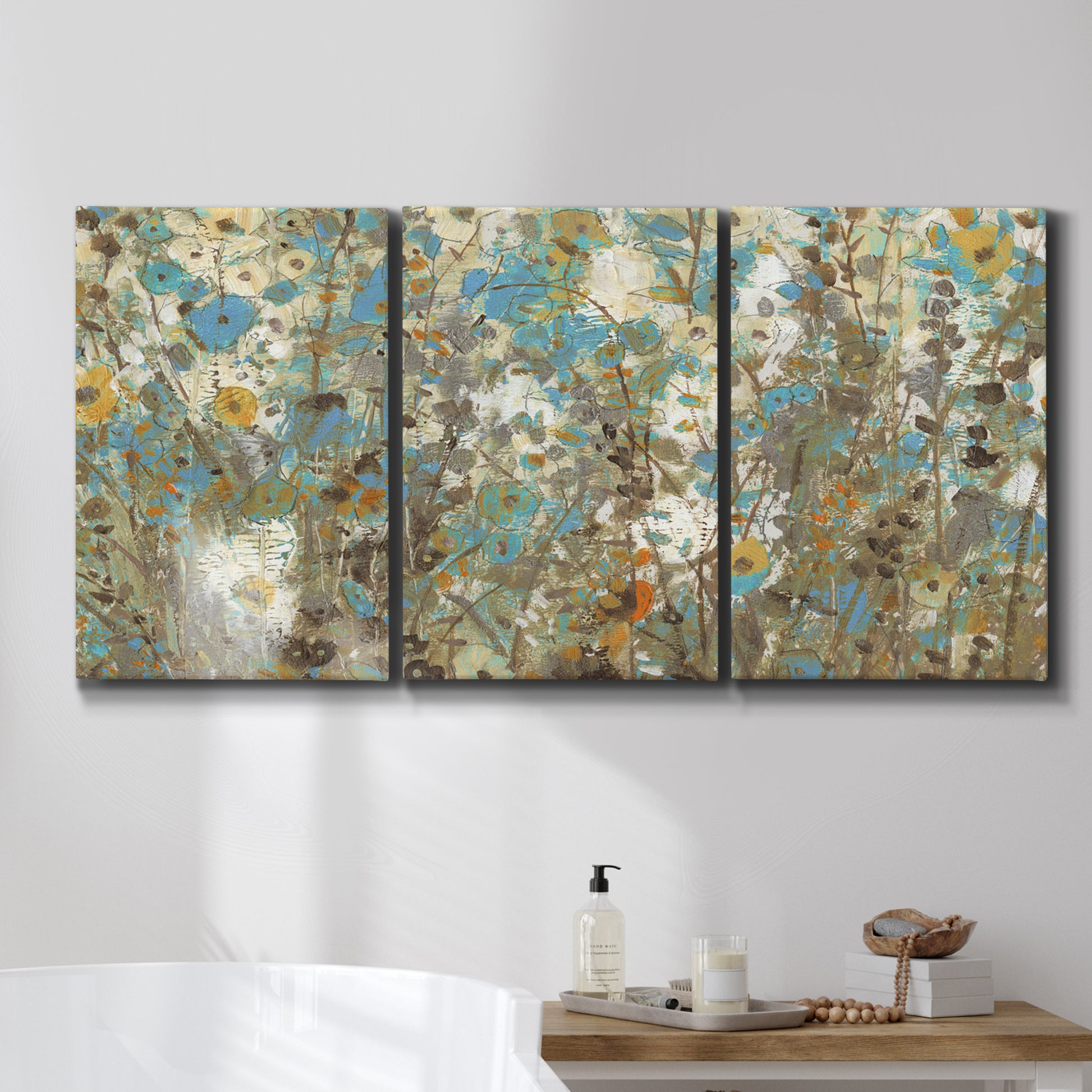 Three-panel canvas wall art featuring abstract flowering vine pattern, displayed in a bathroom above a bathtub.