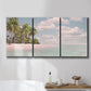 Three-panel canvas wall art featuring tropical sand dunes with palms, displayed in a bathroom above a bathtub.