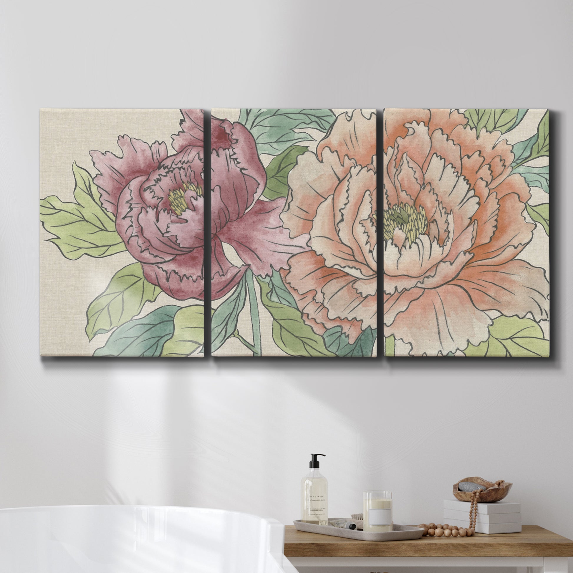 Three-panel canvas wall art featuring pastel peony flower composition, displayed in a bathroom above a bathtub.