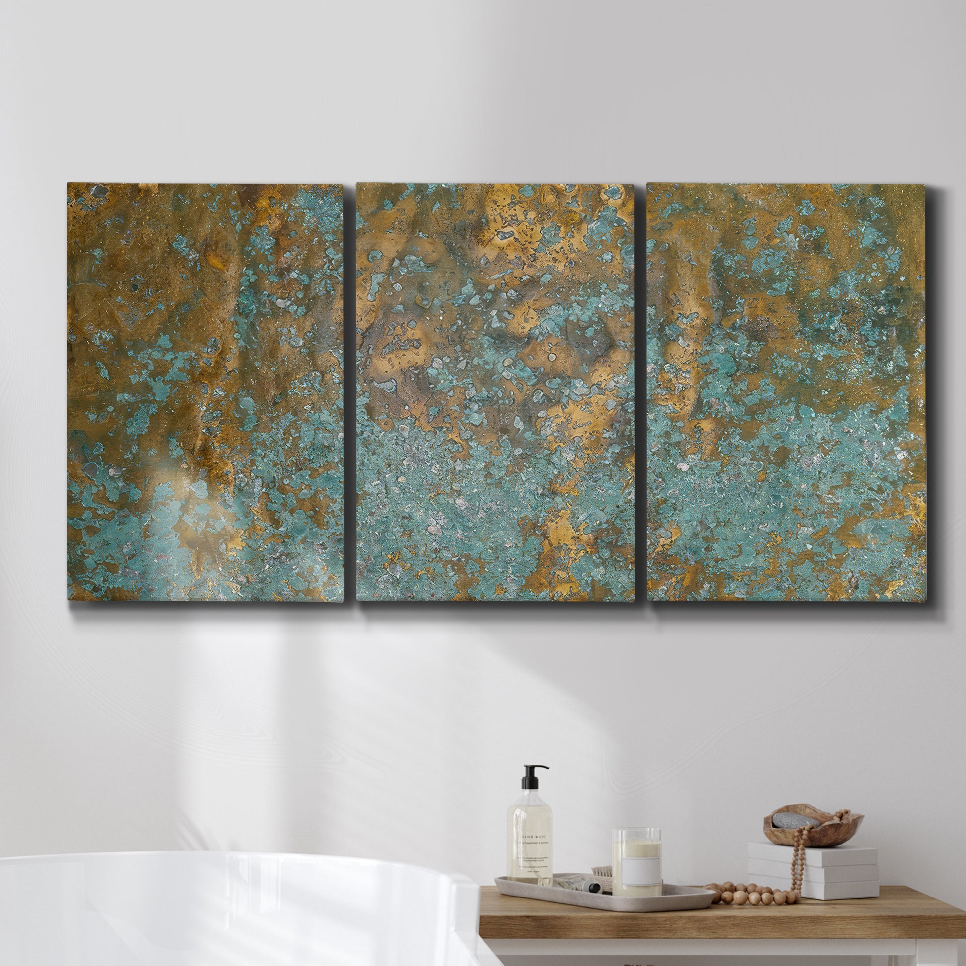 Three-panel canvas wall art featuring earthy copper toned abstract, displayed in a bathroom above a bathtub.