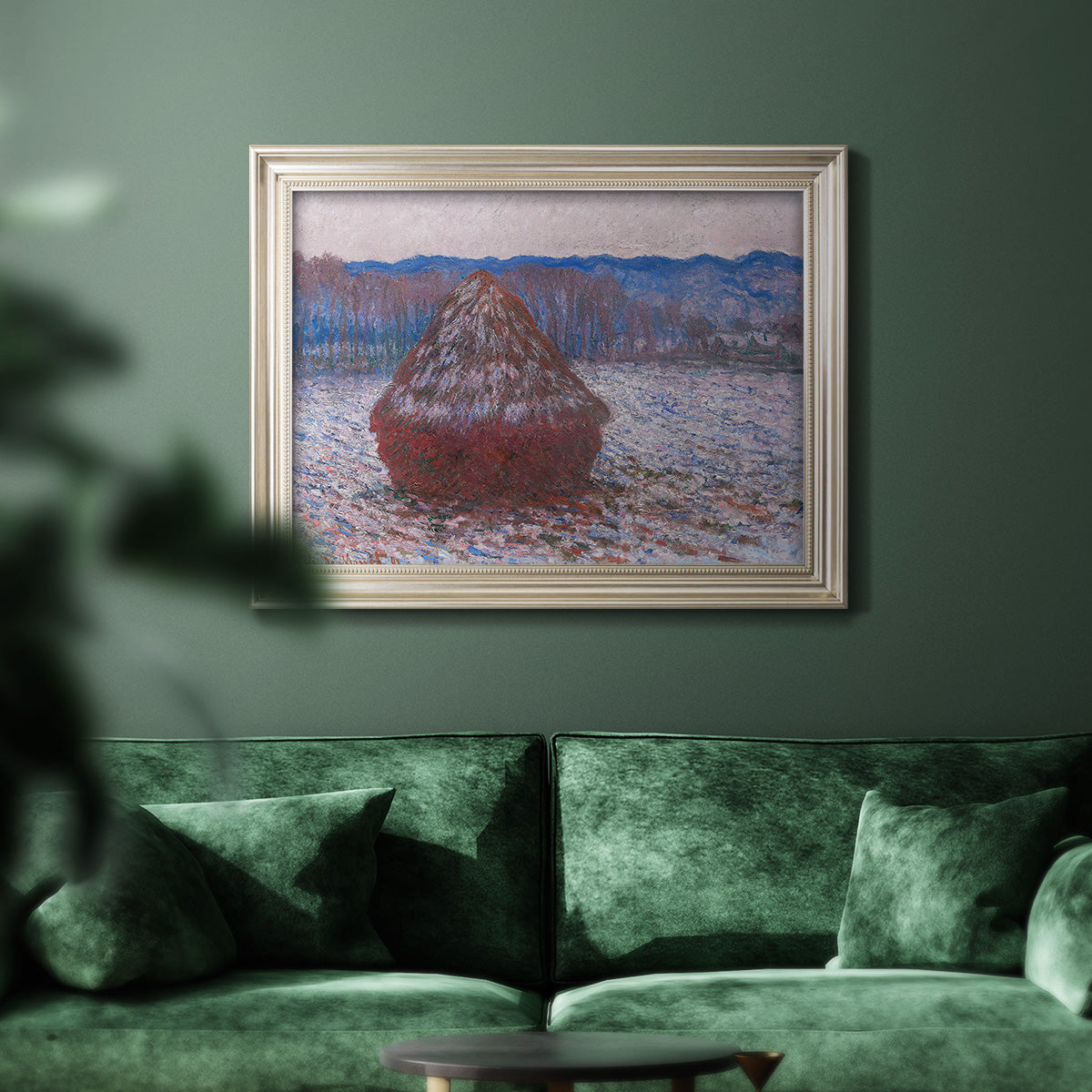 Impressionist single haystack landscape by Claude Monet in an ornate champagne frame displayed in a dark-toned interior setting.