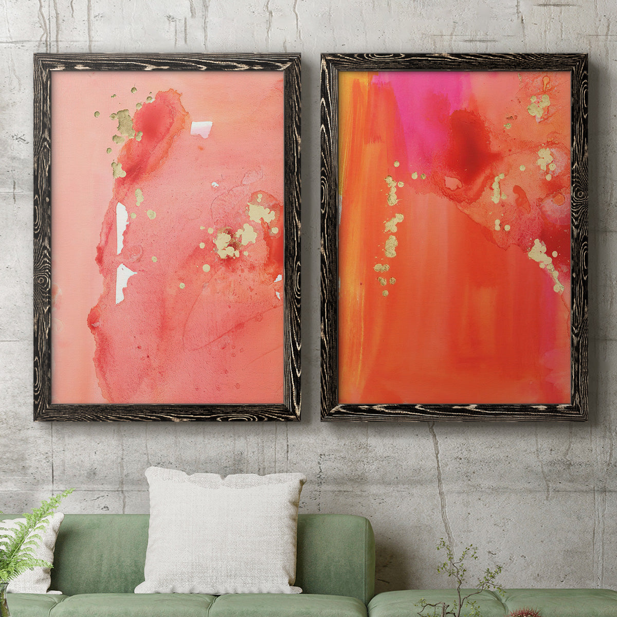 Set of two black barnwood framed canvas prints depicting a coordinated art pair of luminous coral orange and pink color fields with gold flecks rendered as glamorous fluid abstracts above a sofa in a modern living room.