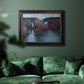 Impressionist rocky seascape by Claude Monet in an ornate black frame with gilded inner detail displayed in a dark-toned interior setting.