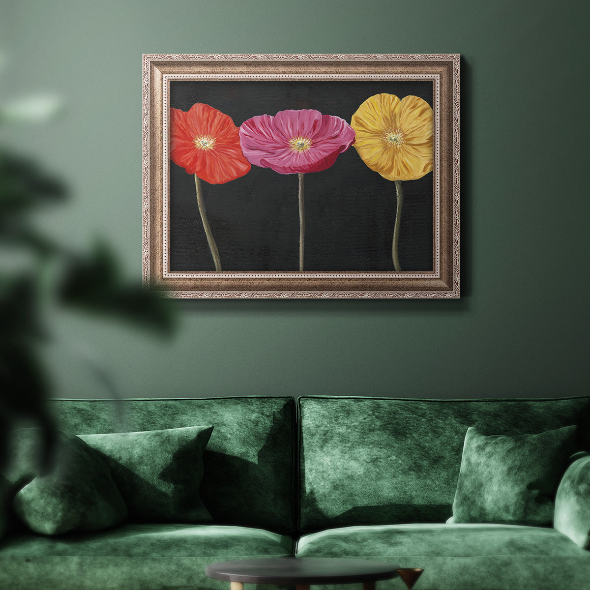 Contemporary poppy flower artwork in an ornate traditional silver frame displayed in a dark-toned interior setting.