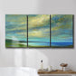 Three-panel canvas wall art featuring coastal shoreline with soft waves, displayed in a bathroom above a bathtub.