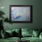 Impressionist industrial harbor scene by Paul Signac in an ornate black frame with gilded inner detail displayed in a dark-toned interior setting.