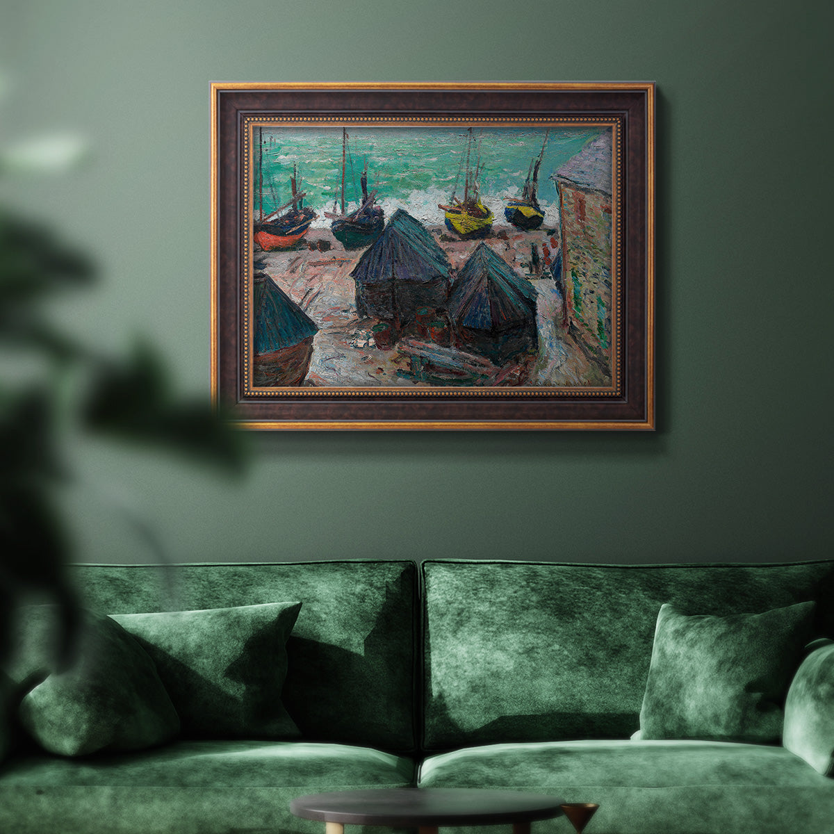 Impressionist coastal beach scene with boats by Claude Monet in an ornate bronzed mahogany wood frame displayed in a dark-toned interior setting.