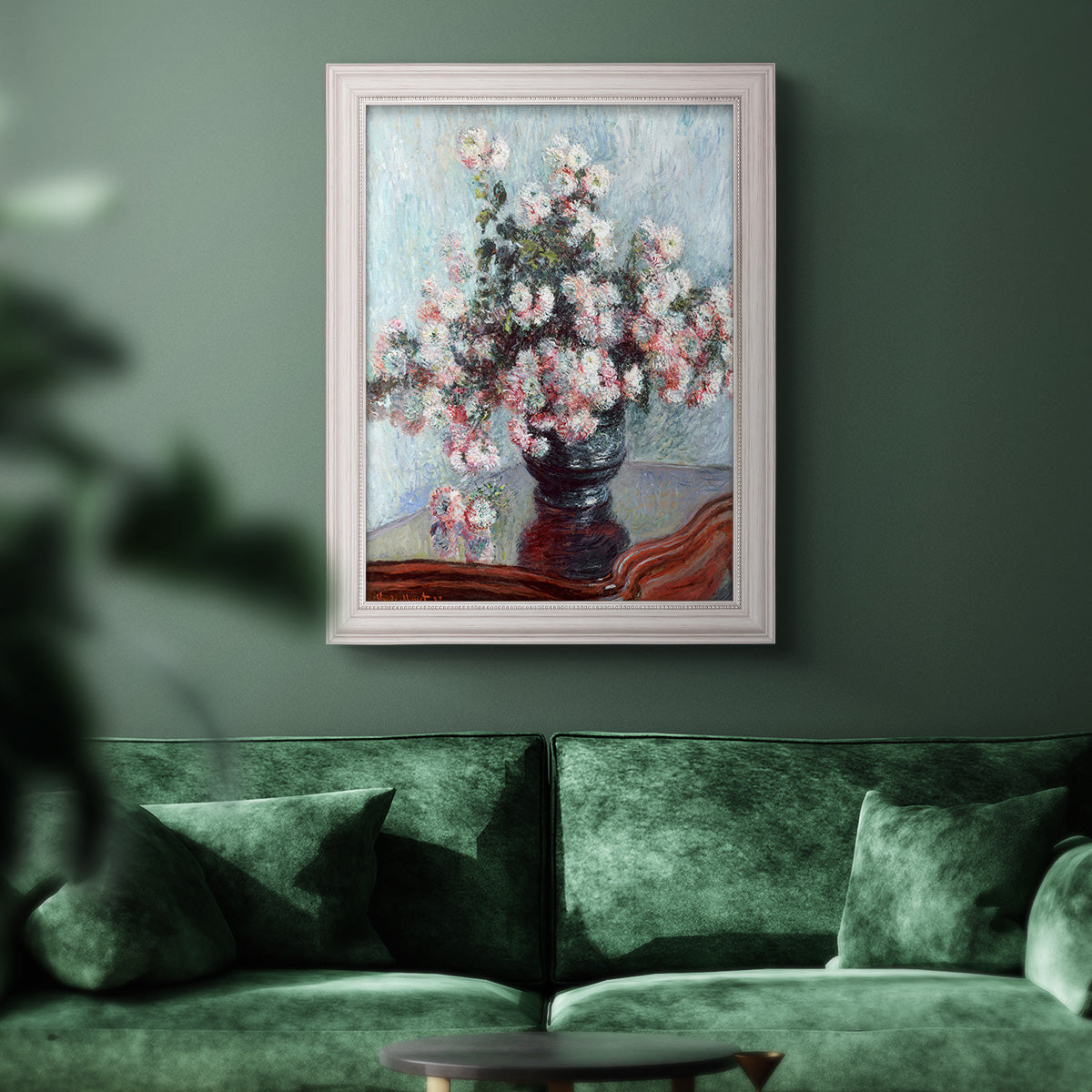 Impressionist chrysanthemum floral painting by Claude Monet in an ornate weathered white frame displayed in a dark-toned interior setting.