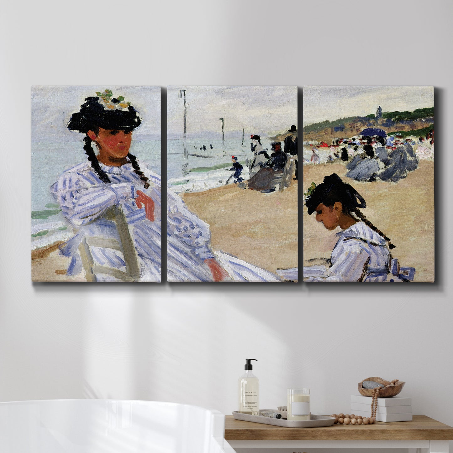 Three-panel canvas wall art featuring figures walking along sandy beach, displayed in a bathroom above a bathtub.