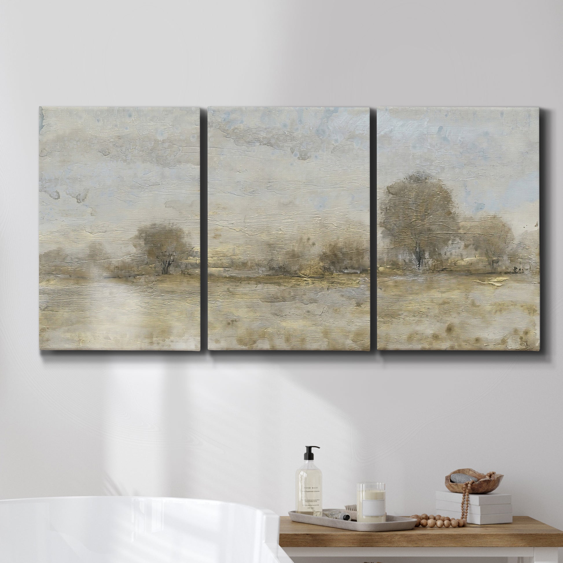 Three-panel canvas wall art featuring late season rural harvest fields, displayed in a bathroom above a bathtub.