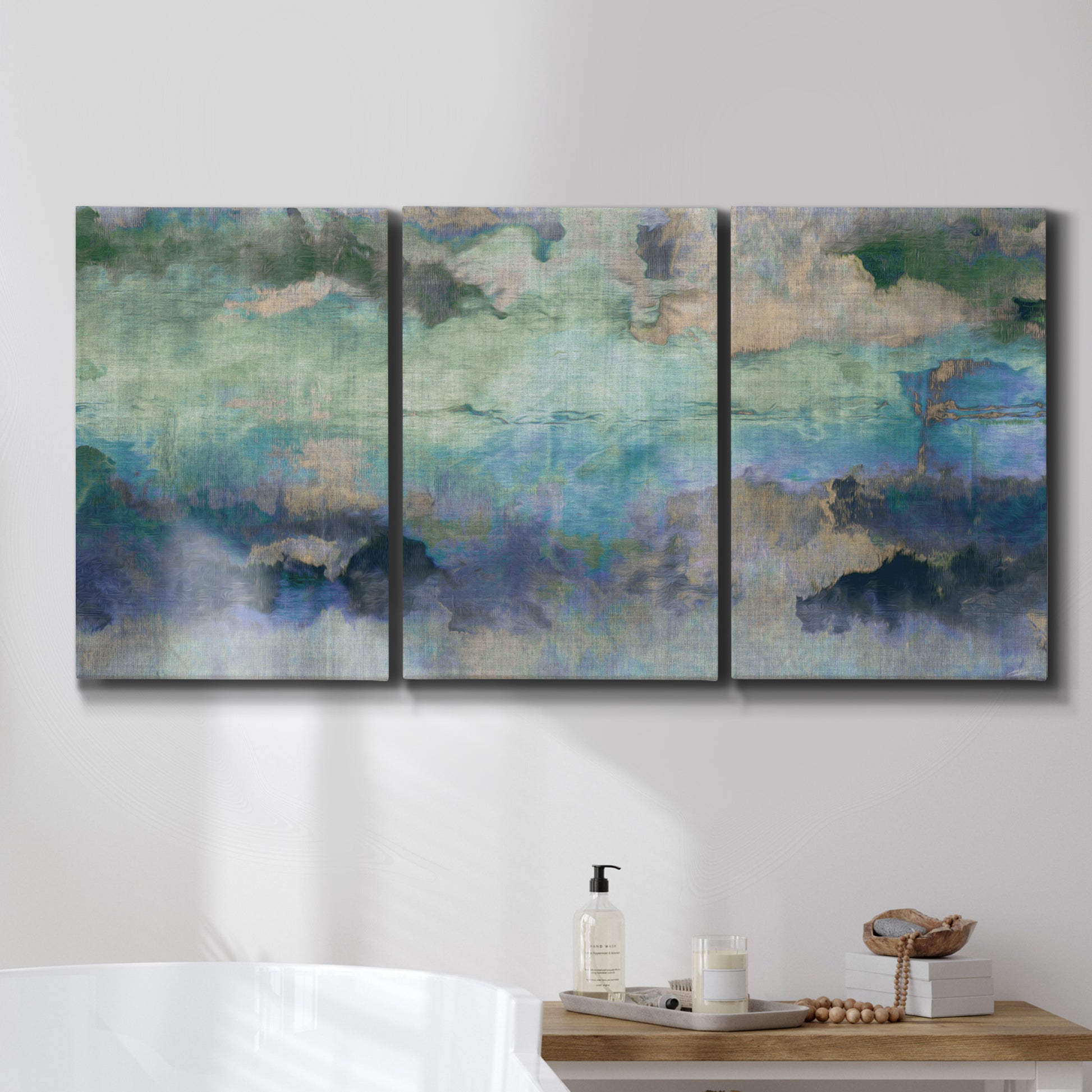 Three-panel canvas wall art featuring cool dreamy abstraction, displayed in a bathroom above a bathtub.