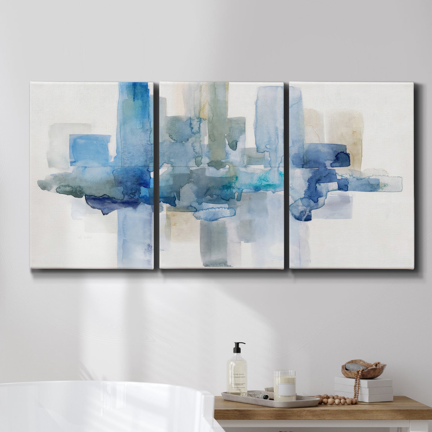 Three-panel canvas wall art featuring minimal urban skyline watercolor, displayed in a bathroom above a bathtub.