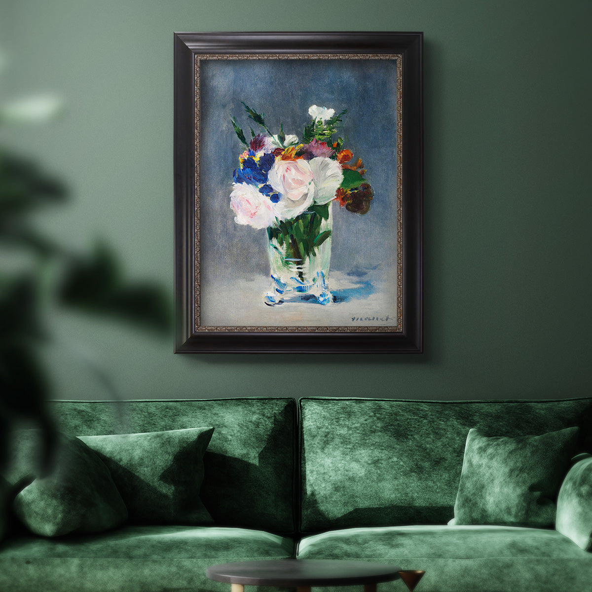 Impressionist floral still life painting by Claude Monet in an ornate black frame with gilded inner detail displayed in a dark-toned interior setting.
