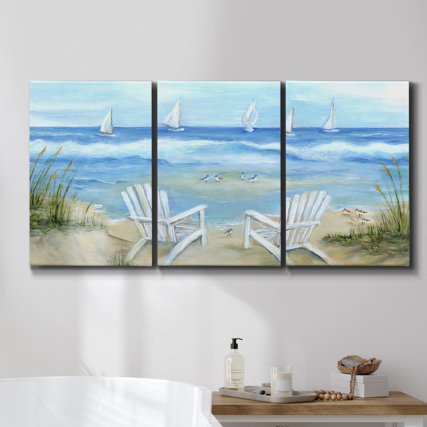 Three-panel canvas wall art featuring peaceful coastal landscape escape, displayed in a bathroom above a bathtub.