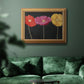Contemporary poppy flower artwork in an ornate antique gold frame displayed in a dark-toned interior setting.