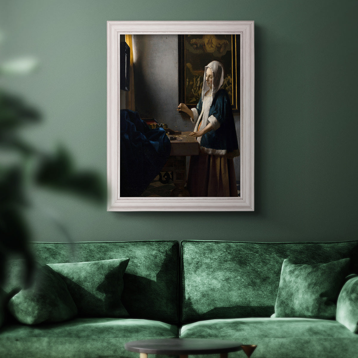 Quiet interior genre scene of a woman with scales by Johannes Vermeer in an ornate weathered white frame displayed in a dark-toned interior setting.
