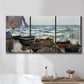 Three-panel canvas wall art featuring rough coastal seas under storm clouds, displayed in a bathroom above a bathtub.