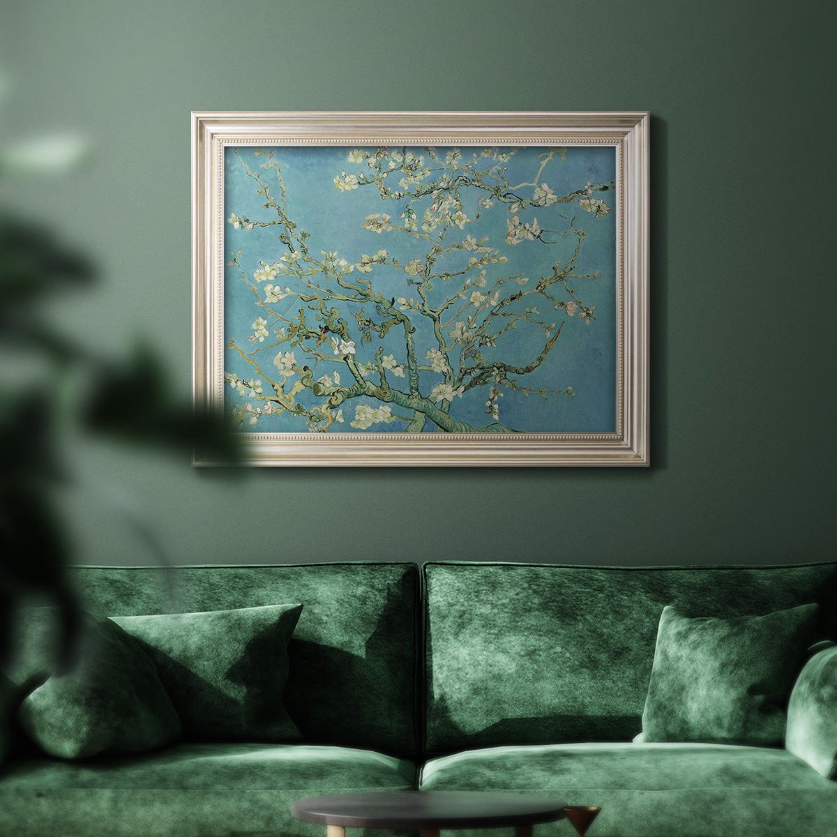 Impressionist flowering almond branch painting by Vincent van Gogh in an ornate champagne frame displayed in a dark-toned interior setting.