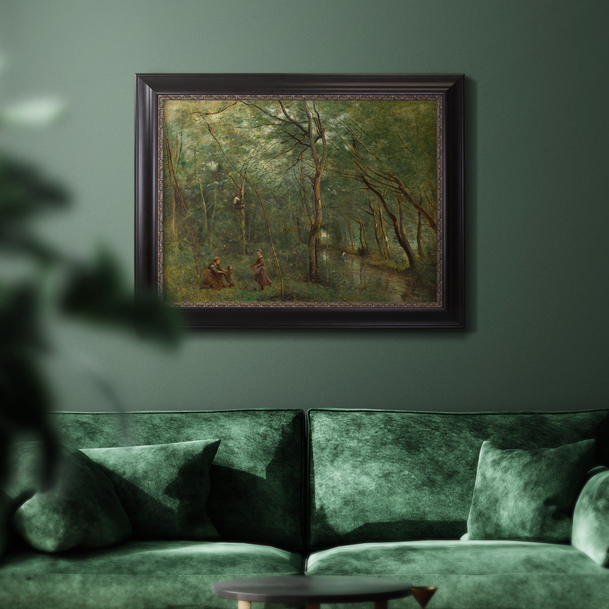 Traditional rural landscape scene with figures by Jean-Baptiste-Camille Corot in an ornate black frame with gilded inner detail displayed in a dark-toned interior setting.