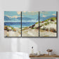 Three-panel canvas wall art featuring sand dunes beside open water, displayed in a bathroom above a bathtub.