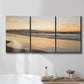 Three-panel canvas wall art featuring quiet tropical shoreline at low tide, displayed in a bathroom above a bathtub.