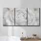 Three-panel canvas wall art featuring monochrome rose study photograph, displayed in a bathroom above a bathtub.