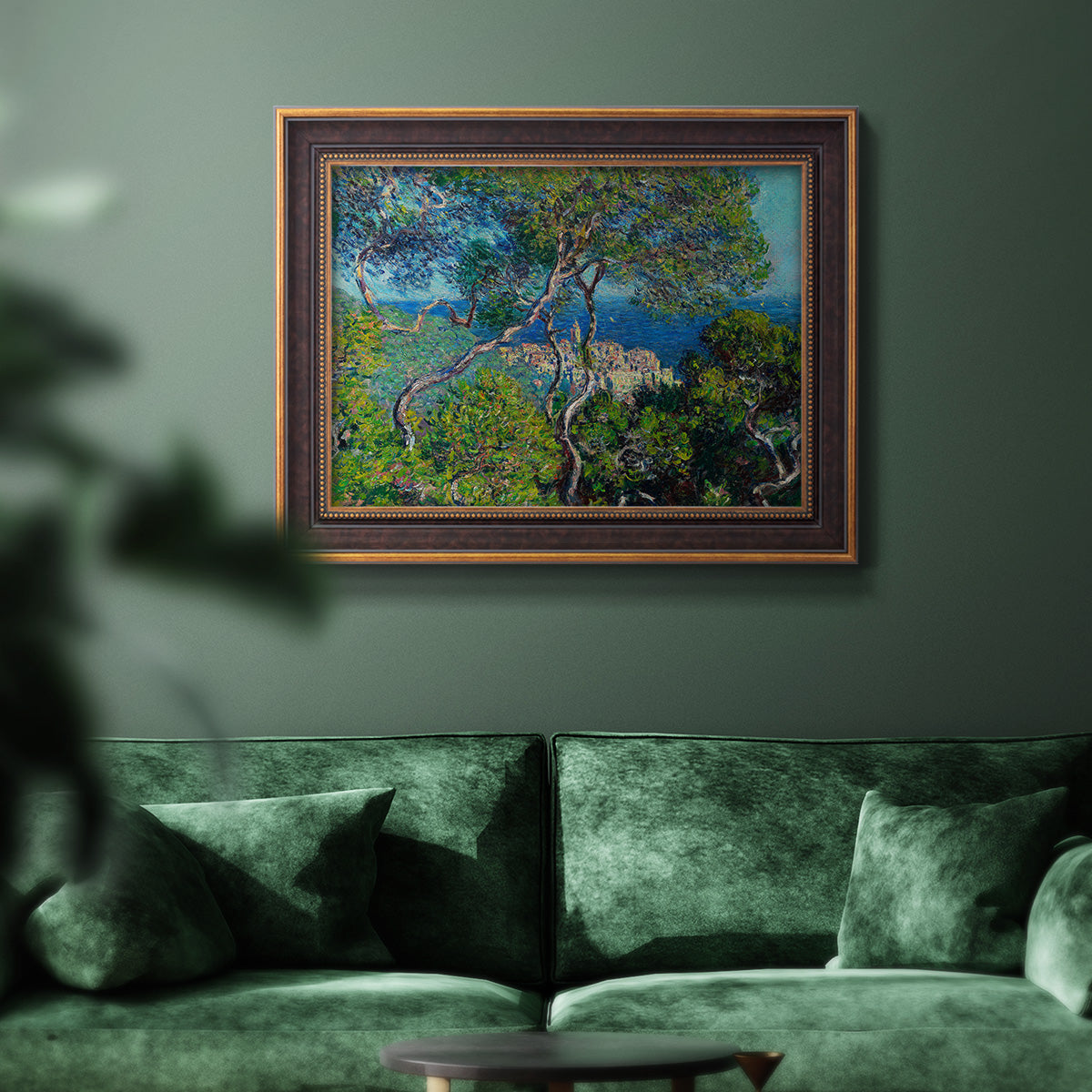 Impressionist Mediterranean coastal landscape by Claude Monet in an ornate bronzed mahogany wood frame displayed in a dark-toned interior setting.