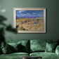 Impressionist wheat harvest scene by Vincent van Gogh in an ornate champagne frame displayed in a dark-toned interior setting.