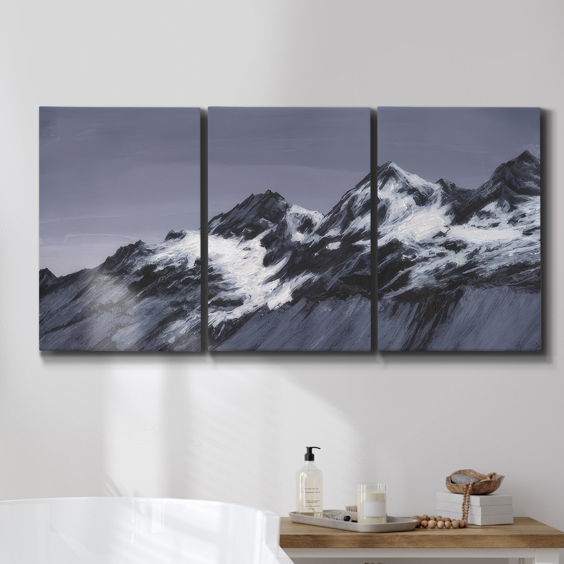 Three-panel canvas wall art featuring moonlit mountain peaks under night sky, displayed in a bathroom above a bathtub.