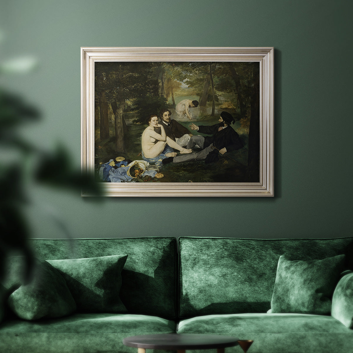 Groundbreaking impressionist picnic scene by Édouard Manet in an ornate champagne frame displayed in a dark-toned interior setting.