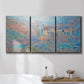 Three-panel canvas wall art featuring sunlit valley landscape, displayed in a bathroom above a bathtub.