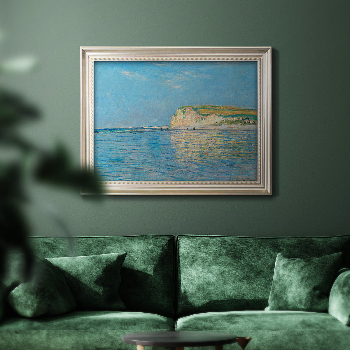 Impressionist coastal low-tide seascape at Pourville by Claude Monet in an ornate champagne frame displayed in a dark-toned interior setting.