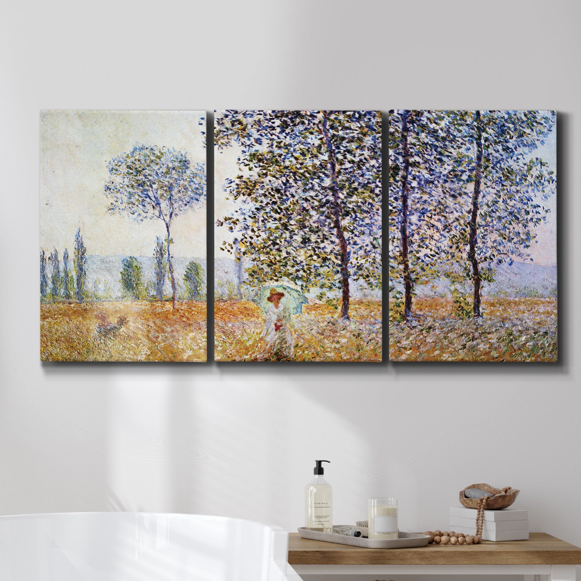 Three-panel canvas wall art featuring three poplar trees beside water, displayed in a bathroom above a bathtub.