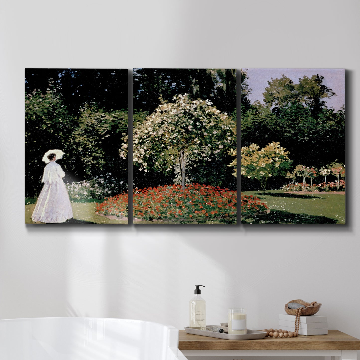 Three-panel canvas wall art featuring woman seated in garden landscape, displayed in a bathroom above a bathtub.