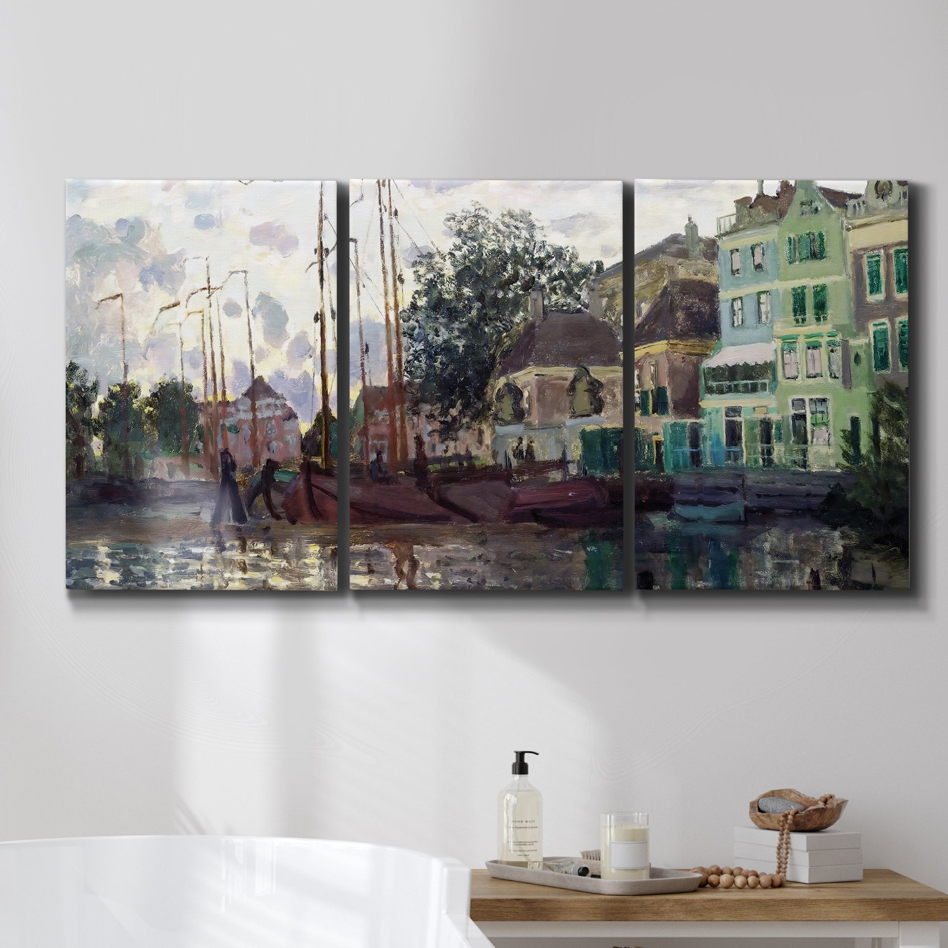 Three-panel canvas wall art featuring riverside town dike at evening, displayed in a bathroom above a bathtub.
