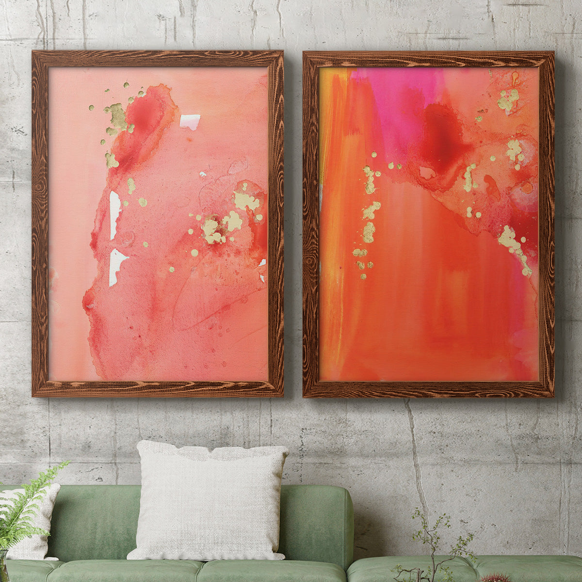 Set of two maple barnwood framed canvas prints depicting a coordinated art pair of luminous coral orange and pink color fields with gold flecks rendered as glamorous fluid abstracts above a sofa in a modern living room.