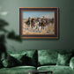 Impressionist western action scene by Frederic Remington in an ornate bronzed mahogany wood frame displayed in a dark-toned interior setting.