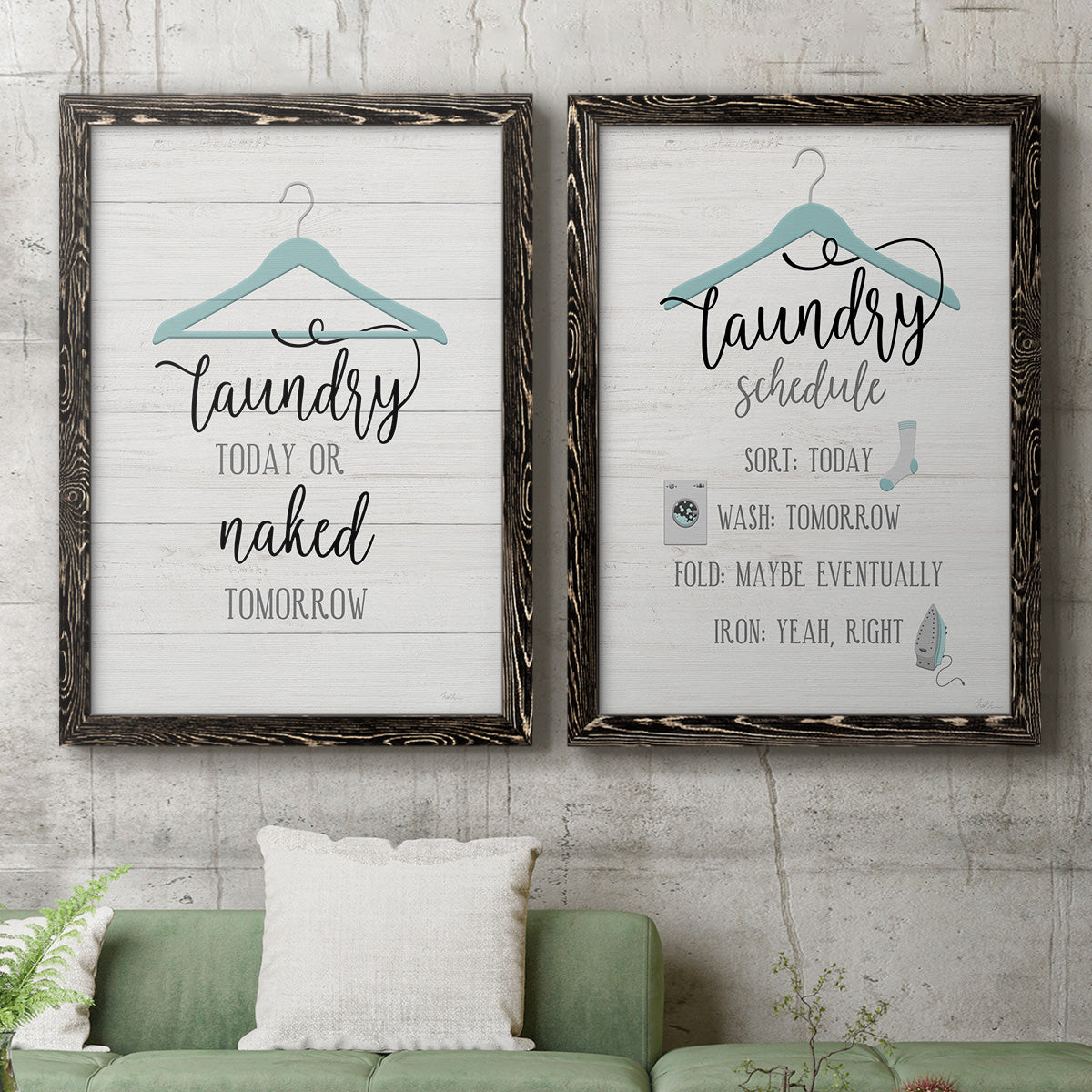Set of two black barnwood framed canvas prints depicting a coordinated art pair of humorous laundry-room sayings and clothing icons rendered as rustic typographic wall art above a sofa in a modern living room.
