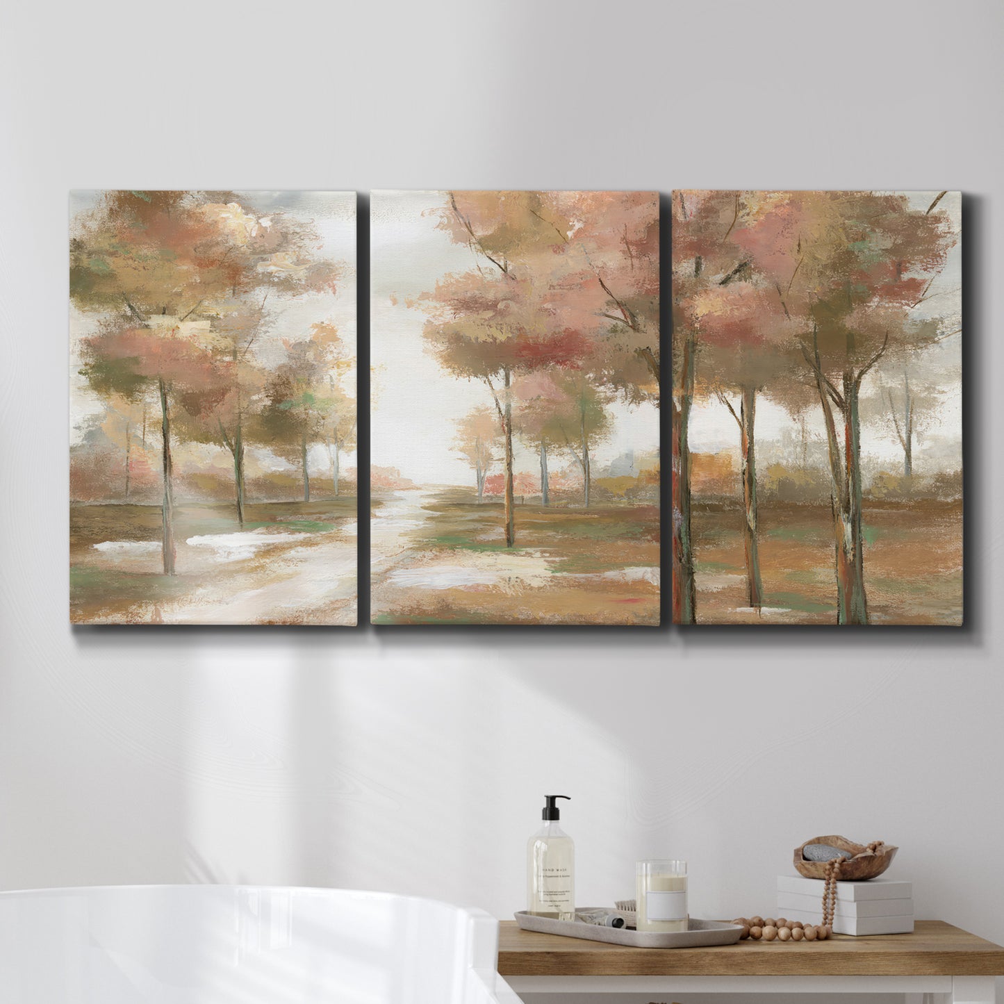Three-panel canvas wall art featuring soft pastel park landscape scene, displayed in a bathroom above a bathtub.