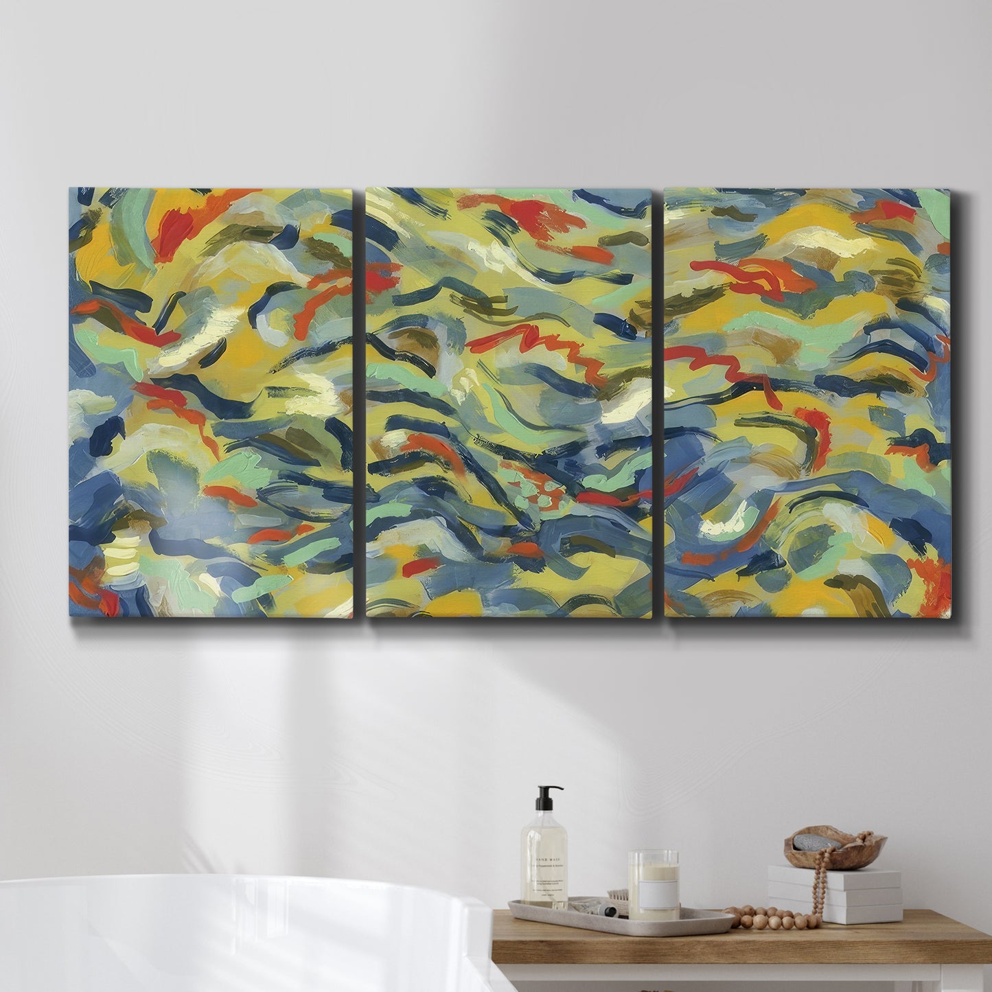 Three-panel canvas wall art featuring colorful abstract river like motion, displayed in a bathroom above a bathtub.