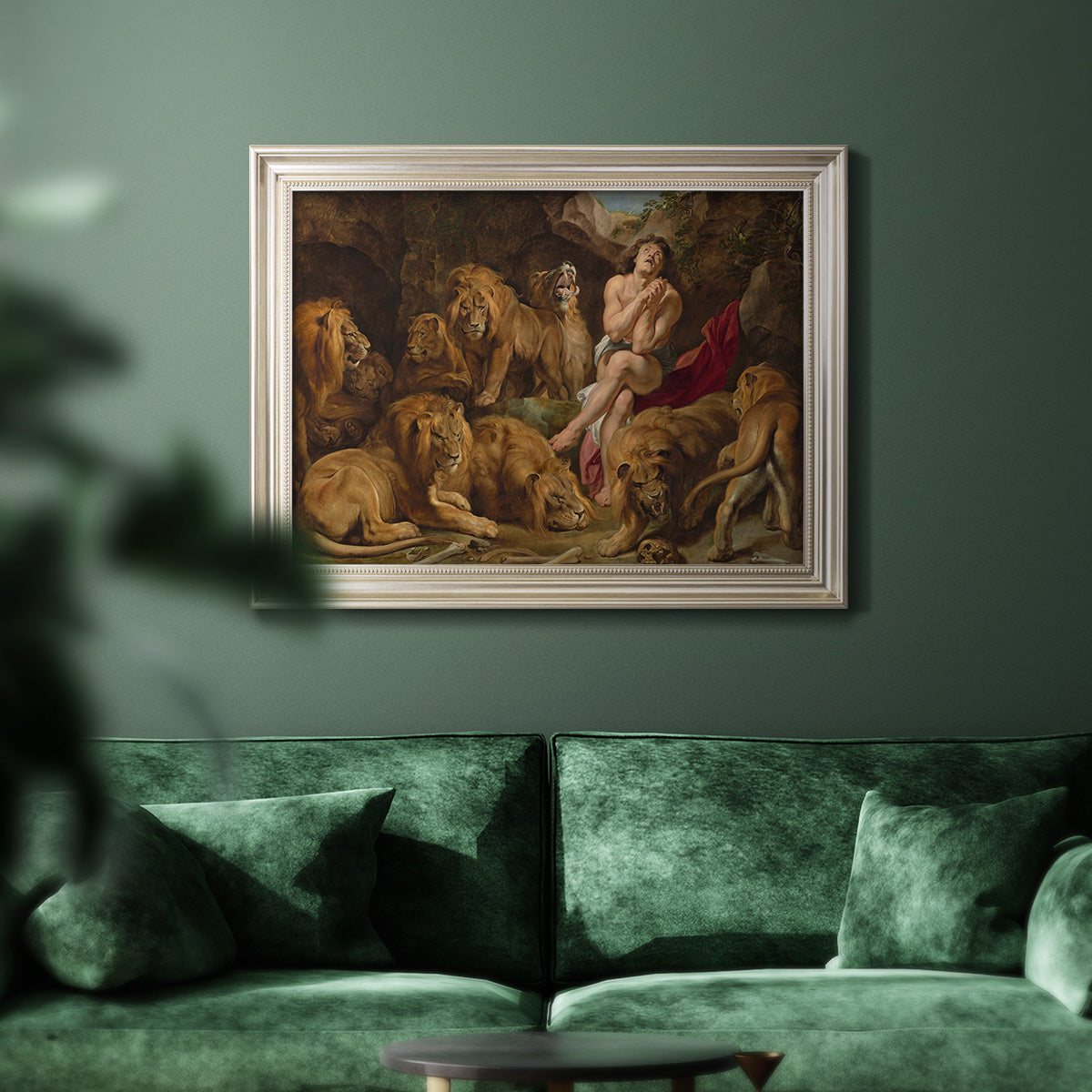 Dramatic biblical painting of Daniel with lions by Peter Paul Rubens in an ornate champagne frame displayed in a dark-toned interior setting.