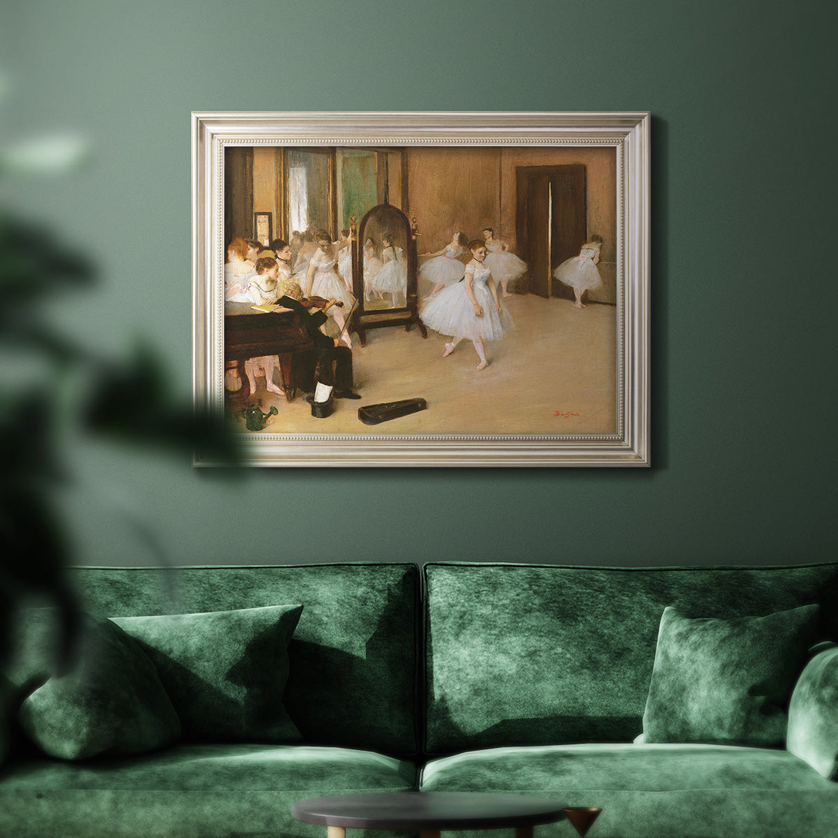 Impressionist dance class interior scene by Edgar Degas in an ornate champagne frame displayed in a dark-toned interior setting.