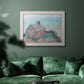 Impressionist coastal building landscape by Claude Monet in an ornate weathered white frame displayed in a dark-toned interior setting.