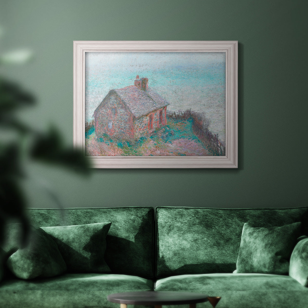 Impressionist coastal building landscape by Claude Monet in an ornate weathered white frame displayed in a dark-toned interior setting.