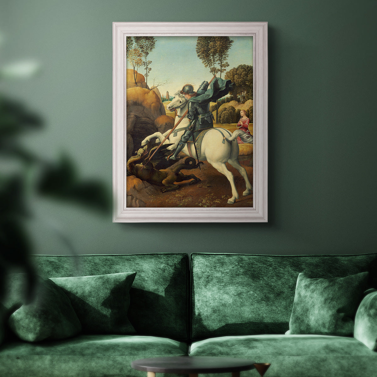 Religious painting of Saint George slaying the dragon by Raphael in an ornate weathered white frame displayed in a dark-toned interior setting.